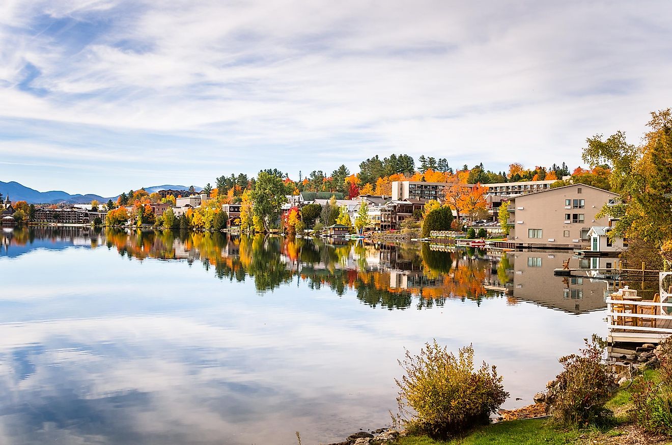 Mountain village in autumn with reflection in water, Lake Placid, Upstate New York.