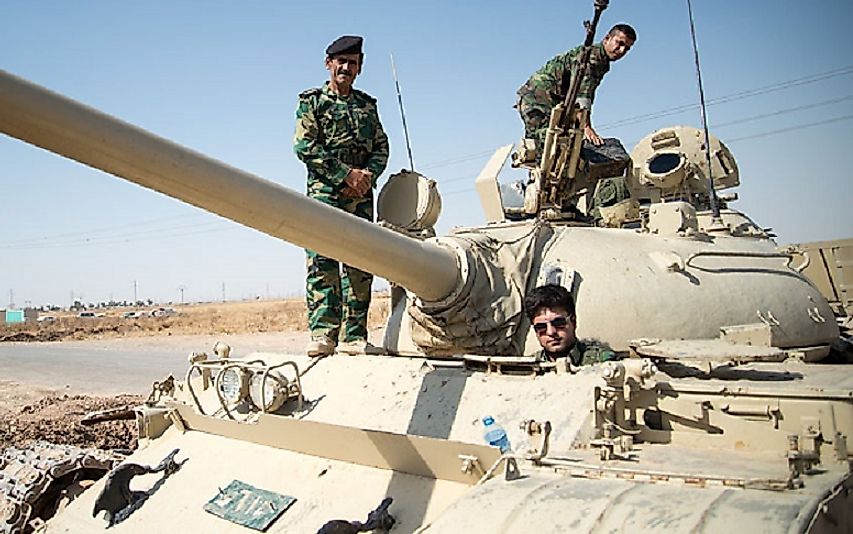 Members of a Peshmerga armored battalion on a Soviet surplus T-55 main battle tank as they prepare to confront ISIL forces in 2014.