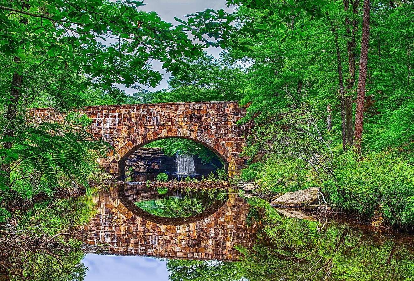 Foliage reflections of scenic Davies Bridge in Petit Jean State Park near Russellville, Arkansas.