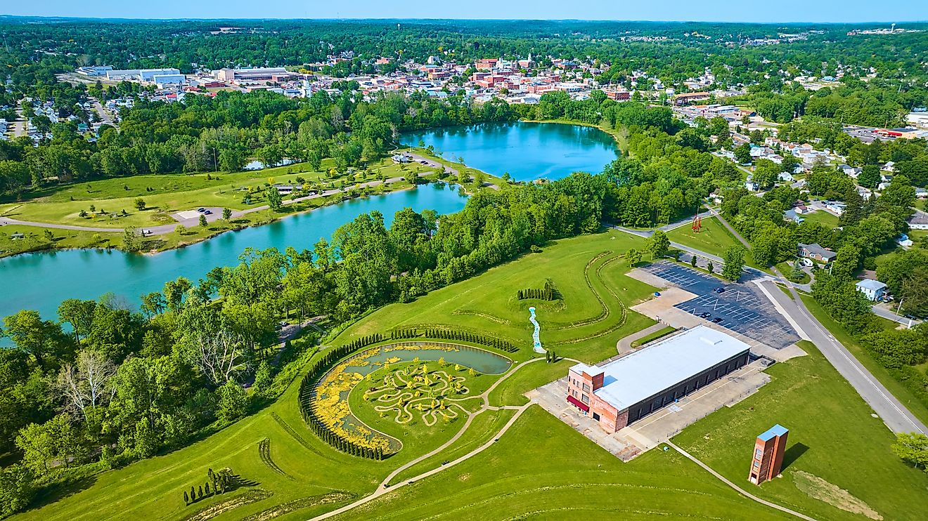 Summertime aerial view of Mount Vernon and Ariel Foundation Park, featuring turquoise pond water in the distance.