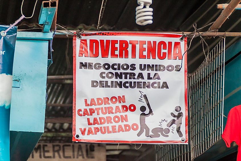 Warning sign at a market in Guatemala. It says: "Warning against delinquency. Captured thief=beaten thief."