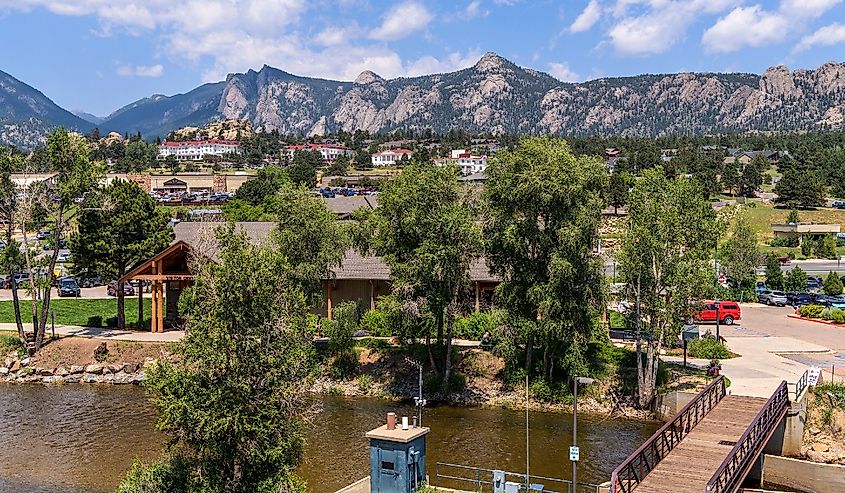 A sunny Summer day view of the center of the mountain resort town Estes Park at side of Big Thompson River. Colorado
