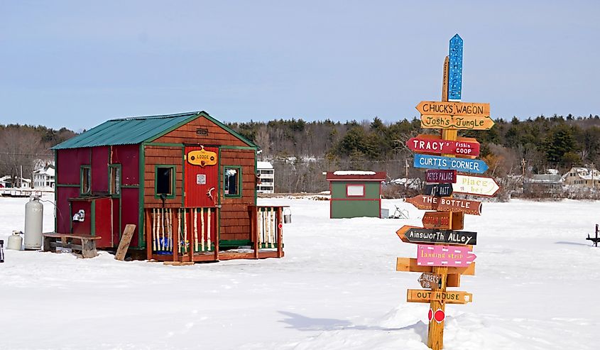 Signs point the way to a multitude of ice fishing shacks on a frozen Lake Winnipesaukee in Meredith