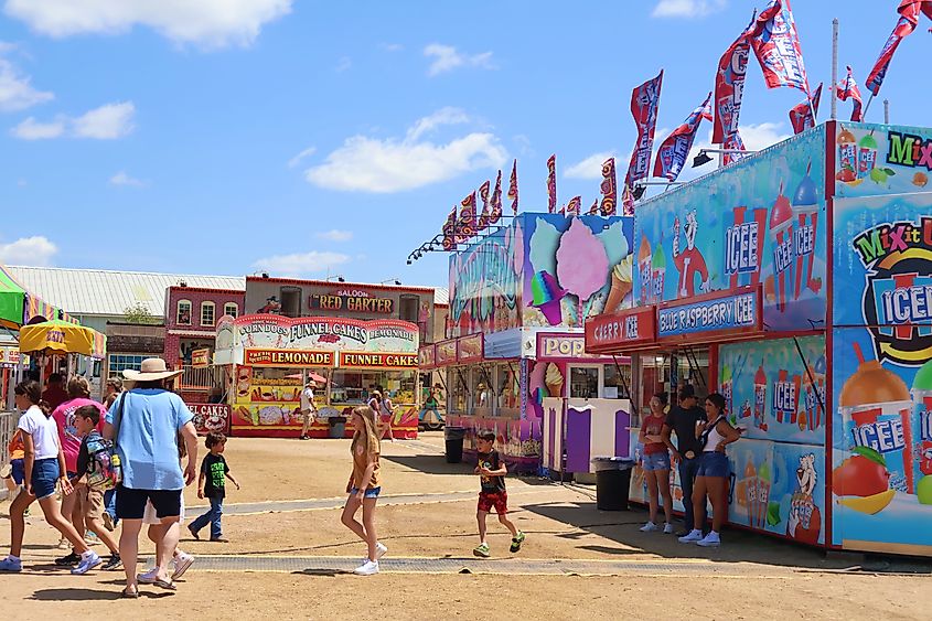 Photograph of various rides and stalls at the Gillespie County Fair in Fredericksburg, Texas