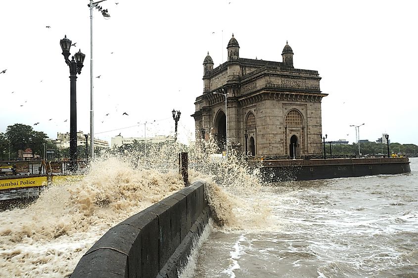 Monsoon high tide waves (4.89 meters high) hit the iconic structure at Gateway of India in Mumbai, India.