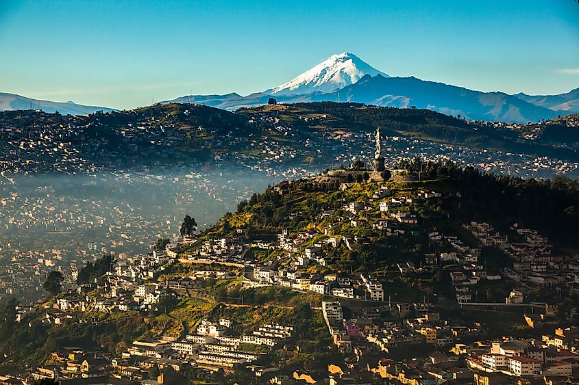 View of El Panecillo in the center of Quito, Ecuador, with the Cotopaxi in the background