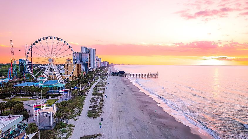 Sunrise at Myrtle Beach, South Carolina, with views of the beach, coastline, and a Ferris wheel