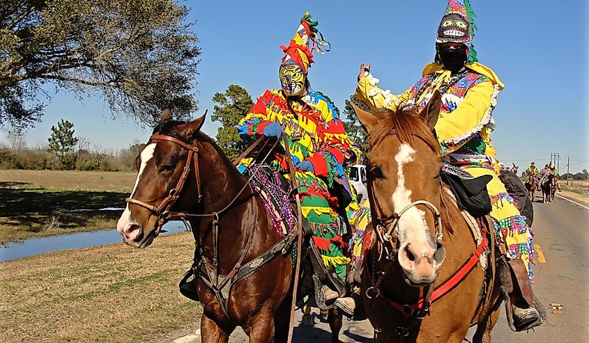 Two Cajun Mardi Gras horseback riders in Eunice, Louisiana. Image credit Elliott Cowand Jr via Shutterstock.