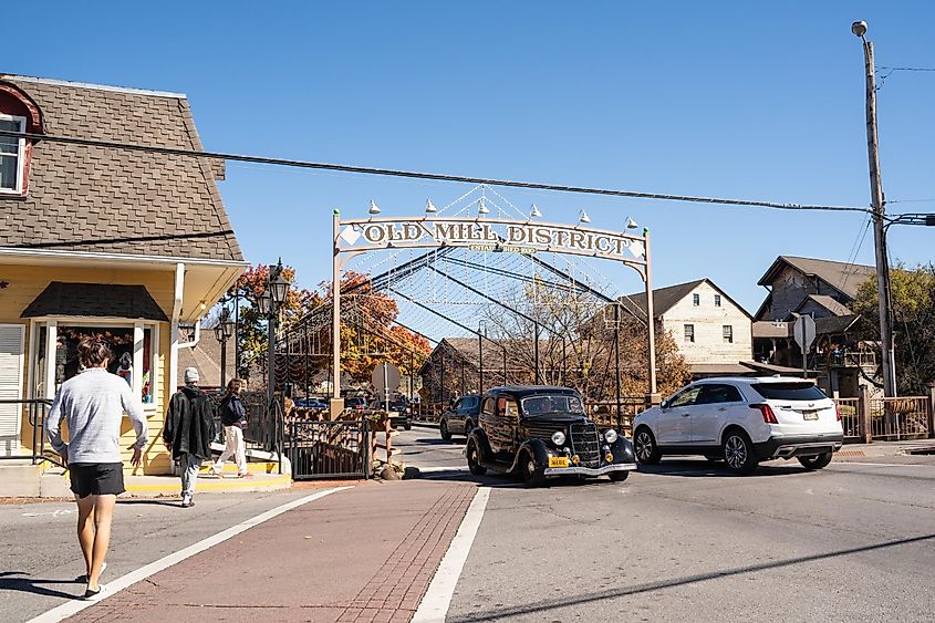 View of historic Old Mill District in the tourist area of Pigeon Forge TN on a sunny autumn day, via littlenySTOCK / Shutterstock.com