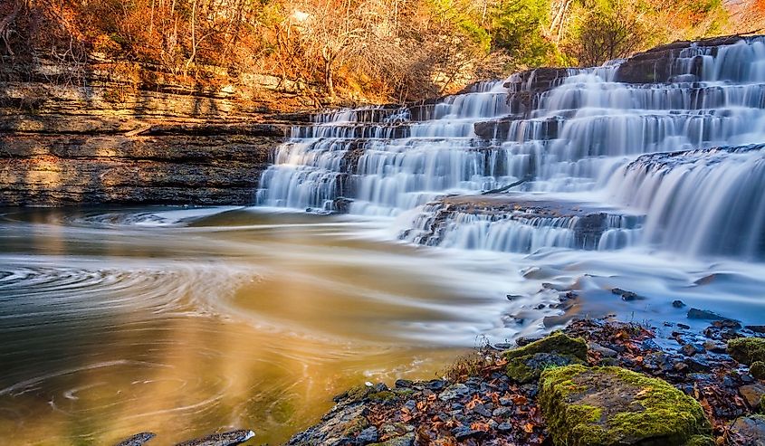 Silky water cascades over limestone rock at Burgess Falls State Park in Tennessee.